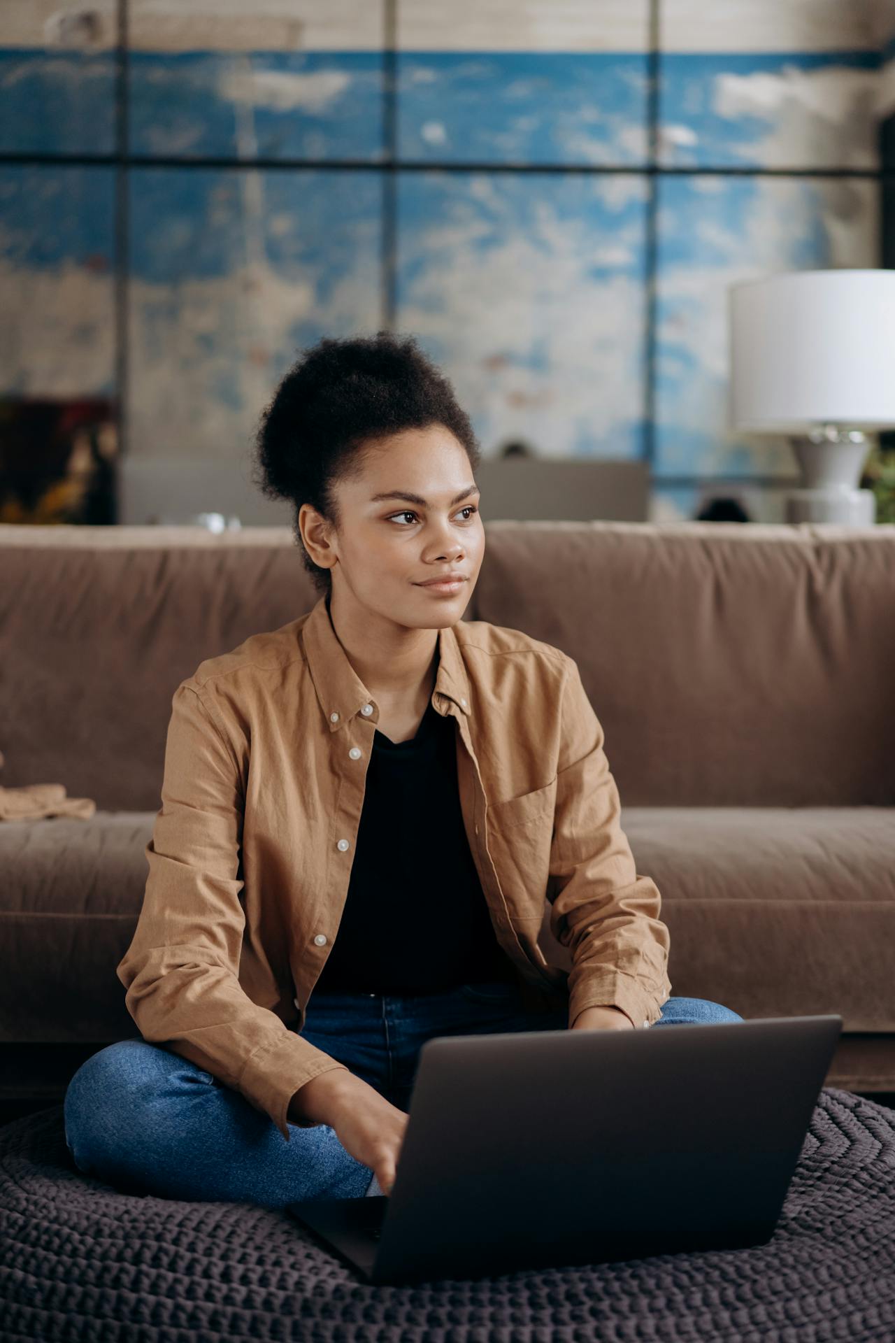 lady sitting working on a laptop in sitting room